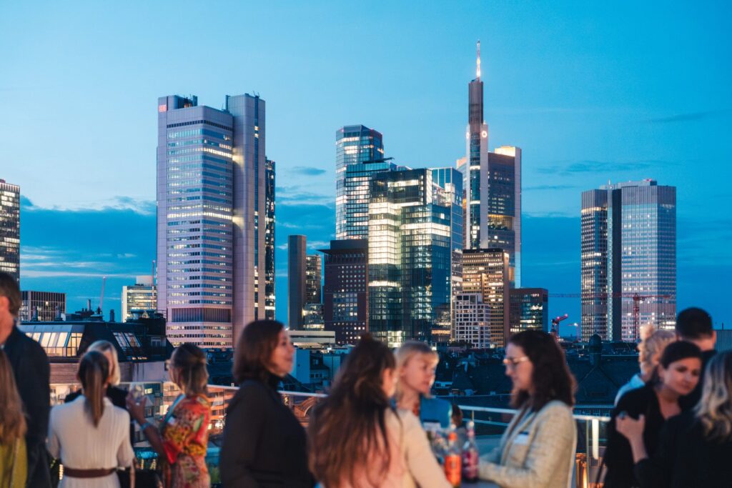 Evening reception on a rooftop terrace overlooking the Frankfurt skyline