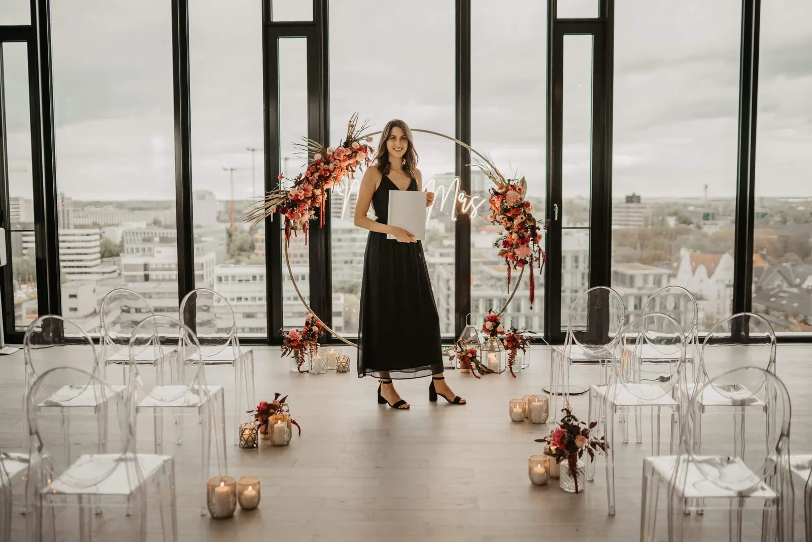 A non-religious wedding ceremony with a floral arch at an event venue in Düsseldorf